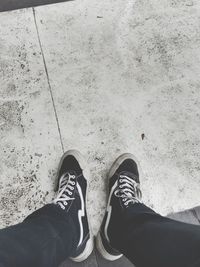 Low section of man standing on tiled floor