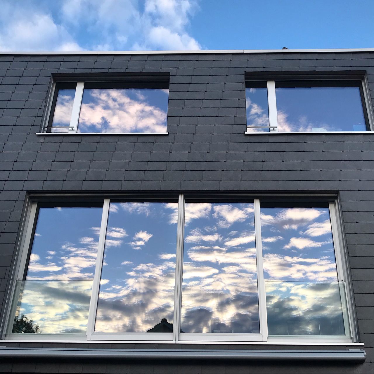 sky, window, cloud - sky, glass - material, low angle view, built structure, architecture, building exterior, building, no people, reflection, nature, transparent, day, outdoors, house, sunlight, glass, blue, window frame