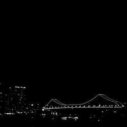 Low angle view of illuminated bridge against sky at night