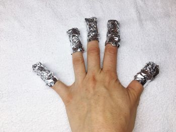 High angle view of human feet on hand