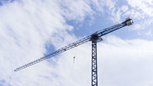 Low angle view of crane against sky