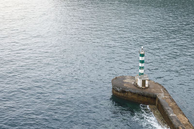 High angle view of lighthouse on pier at sea