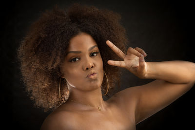 Portrait of a beautiful young woman over black background