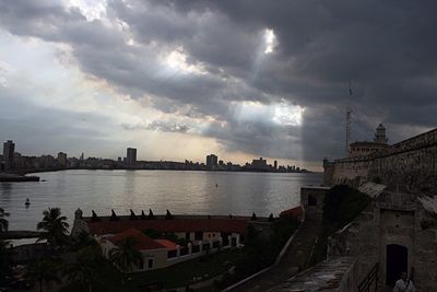 View of harbor against cloudy sky