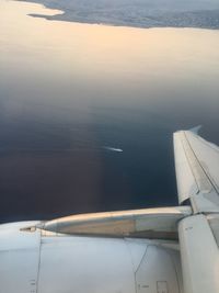 Cropped image of airplane flying over sea