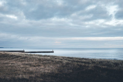 Scenic view of sea against cloudy sky