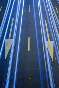 High angle view of arrow sign on road in city