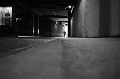 Man walking in illuminated corridor of building