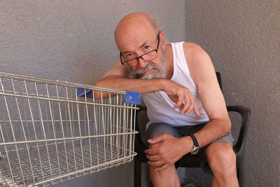 Portrait of senior man homeless in town 