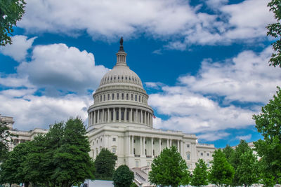 Low angle view of building against cloudy sky