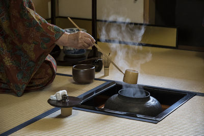 Close-up of man preparing tea 