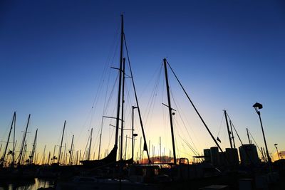Silhouette boats against clear sky at sunset