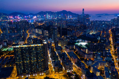 High angle view of illuminated city buildings at night