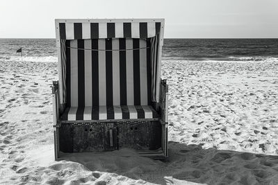 Built structure on beach against sky
