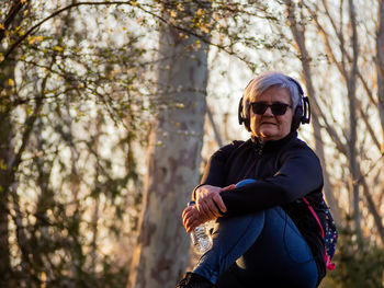 Portrait of man wearing sunglasses in forest