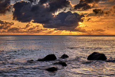 Scenic view of sea against sky at sunset