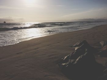 Scenic view of beach against sky during sunset