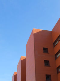 Low angle view of building against clear blue sky