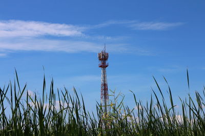 Low angle view of communications tower against sky