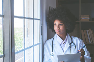 Doctor looking through window at clinic