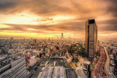 High angle view of cityscape against cloudy sky