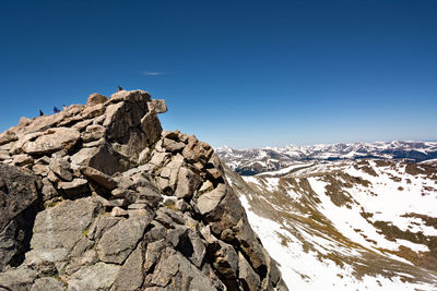 Snowed rocky landscape against blue sky