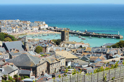 High angle view of townscape by sea against sky