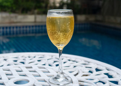 Close-up of drink on table at swimming pool