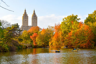 Autumn trees and buildings against sky