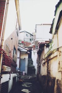 Staircase in city against sky