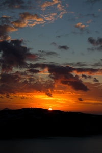 Scenic view of dramatic sky over sea during sunset