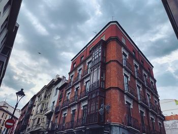 Low angle view of building against cloudy sky