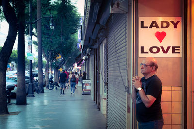 Man standing on street in city