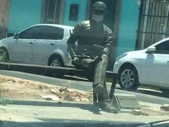 Man standing on road in city