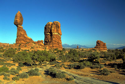 Rock formations against clear blue sky