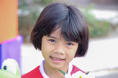 Close-up portrait of girl standing outdoors