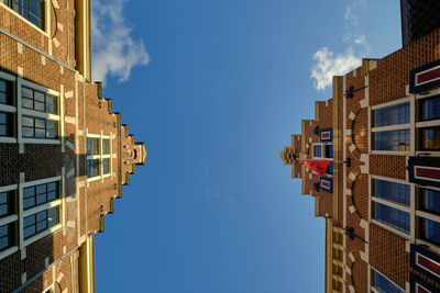 Low angle view of houses with stepped gables in groot heiligland street, haarlem, the netherlands.