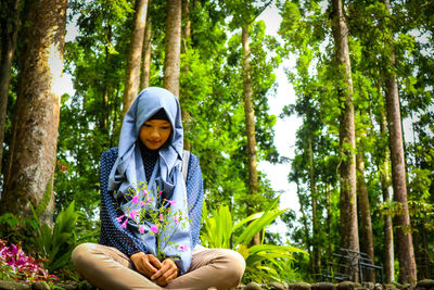 Portrait of woman sitting in park