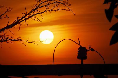 Silhouette tree against orange sky