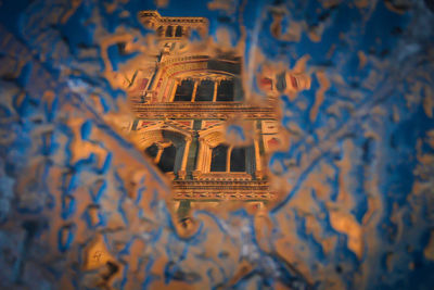 Reflection of cathedral in puddle