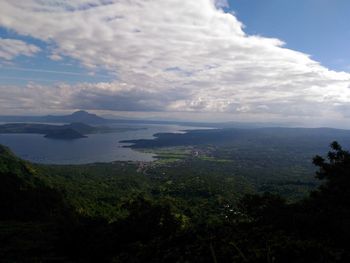 Scenic view of mountains against cloudy sky