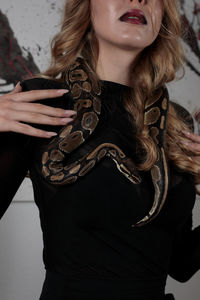 Midsection of young woman holding dog