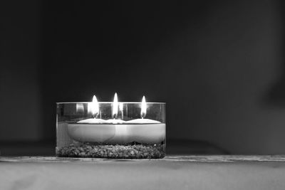 Close-up of burning tea light candles at home