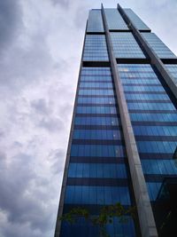 Low angle view of modern glass building against sky