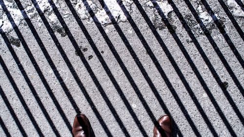 Low section of person on tiled floor