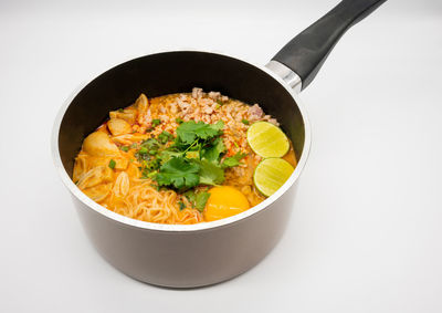 High angle view of food in bowl against white background