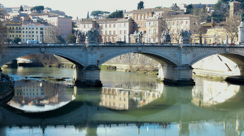 Arch bridge over river in city