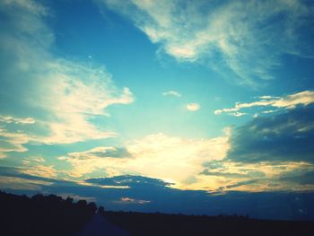 Low angle view of silhouette trees against sky