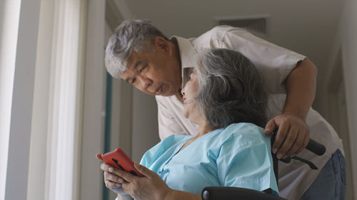 Side view of young woman working at home