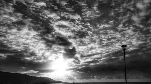 Low angle view of street light against cloudy sky